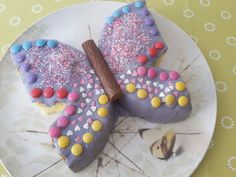 two decorated cookies sitting on top of a white plate