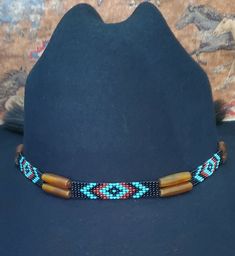 Adjustable Hat Band with GoldenAmber Horn Hairpipe Beads and Native American Indian Style Beading and 2 Tassels with a sliding knot that make this hatband a great fit for most hats. Available in Black or White Horse hair.  This stunning hat band is made from genuine braided horse hair and will compliment your favorite cowboy hat.   - Native American Indian style beadwork with GoldenAmber Horn Hairpipe Beads - Incudes 2 horse hair tassels that measure 3 1/4" long - Hat band measurements: approximately adjusts from  22" to 28" around and is approximately 1/4" inch wide - Hat bands are shown on a size 7 hat.  Hats are not included. - See my horse hair KEEPSAKES to have a hat band made from your horse's hair:  https://www.etsy.com/shop/BlueEyesDesignsHB?ref=seller-platform-mcnav§ion_id=4369774 Handmade Traditional Hat Band For Western-themed Events, Traditional Multicolor Beaded Hat Band, Traditional Beaded Hat Bands For Rodeo, Beaded Brown Hat Band For Festival, Beaded Brown Hat Bands For Festival, Traditional Beaded Hat Bands For Country Events, Adjustable Beaded Bohemian Headpiece, Festival Brown Beaded Hat Bands, Traditional Brown Beaded Hat Bands