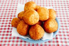 a plate full of fried food sitting on a tablecloth covered table with utensils