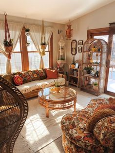 a living room filled with lots of furniture and decor on top of a white rug