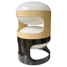 a white and black table with a round object on it's top, sitting in front of a white background