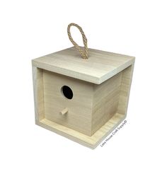 a wooden birdhouse with a rope hanging from it's side