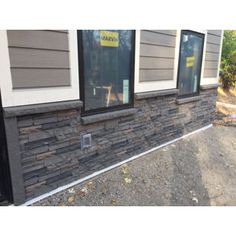 the side of a house with windows and siding