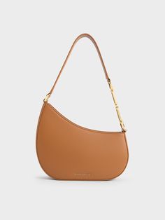 If you are looking for an unconventional crescent bag, then this Agatha shoulder bag in brown will be right up your alley. It features a sleek and structured asymmetrical half-moon design that will have you looking effortlessly chic the moment you sling it on. Plus, the curved design will ensure this shoulder bag will sit comfortably under your arm. The geometric-shaped chain accents add subtle shine and polished sophistication. Crescent Bag, Charles Keith, Moon Design, Half Moon, Crescent, Sleek, Moon, Shoulder Bag, Chain