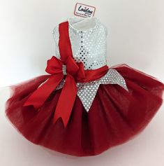 a red and white tutule dress with polka dots on the bottom, bow at the waist