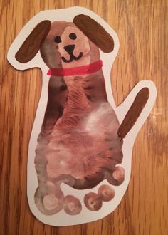 a paper cut out of a dog sitting on top of a wooden table