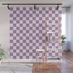 a purple and white checkerboard wallpaper in an empty room with wooden floors