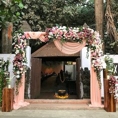 the entrance to a wedding venue decorated with pink and white flowers