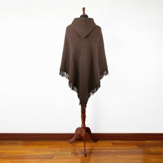 Introducing our exclusive unisex poncho, meticulously handcrafted from the finest llama wool yarn. This poncho is not just a garment; it's a blend of tradition and comfort. Its lightweight yet warm nature makes it an ideal choice for various settings. Key Features: Size: One Size, Approximately 48" Width x 43" Height / 122 cm Width x 110 cm Height, including fringe. Craftsmanship: Each poncho is a unique creation, handwoven by skilled indigenous artisans. Texture: soft to the touch, ensuring no Winter Cashmere Poncho One Size, Handwoven Alpaca Poncho For Fall, Fall Handwoven Alpaca Poncho, Cozy Alpaca Poncho For Winter, Cozy Wool Poncho One Size, Brown Cashmere Shawl For Winter, One Size Alpaca Poncho For Fall, Handwoven Brown Poncho For Winter, Cozy Alpaca Cape For Winter