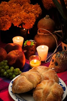 bread, grapes and candles on a table with pumpkins in the background royalty images