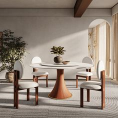 a dining room table with four chairs and a potted plant in the corner on top