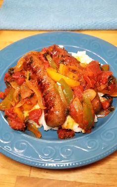 a blue plate topped with meat and vegetables