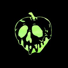 an apple glows green in the dark with a skull on it's side