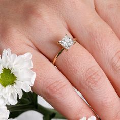 a woman's hand with a diamond ring on it