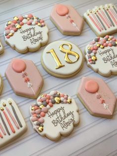 decorated birthday cookies are arranged on a table