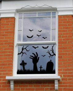 a window decorated with halloween decorations and bats