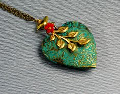 "This unique heart shaped necklace is 24\" long. Vintage bronze heart shaped locket 42mm with beautiful motifs on it is patina and decorated with brass bird, raw brass tree leafy branch, and Czech red glass flower bead. Pendant is hanging from a vintage bronze chain and finished with bronze lobster clasp. Locket opens and have room to put photos in just like other lockets! Thanks for looking:) ~Mani" Bohemian Heart Necklaces For Valentine's Day, Bohemian Heart Necklace For Valentine's Day, Handmade Pendant Locket Necklace For Valentine's Day, Bohemian Heart Jewelry For Valentine's Day, Valentine's Day Locket Necklace, Bohemian Heart Pendant Necklace Gift, Heart Shaped Locket, Large Locket, Brass Bird