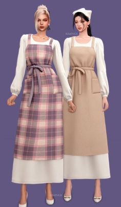 two women in aprons standing next to each other wearing dresses with long sleeves and ties