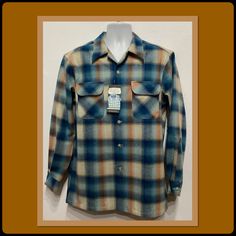 "21 New Pendleton Men's Board Shirt. Currently available in medium, large, X large, and XX large. The 1960s board shirt is one of Pendleton's most popular designs. Made from premium, machine-washable wool. The midweight fabric is water, odor and stain-resistant. The 100% pure virgin wool shirt has a pointed loop collar, five button down front, two rounded flap pockets, long sleeves, double button cuffs and square bottom hem. The label states warranted to be Pendleton. Pendleton woolen mills since 1863. 1964 this pattern inspired by the Pendleton archives. Care Instructions; machine wash with like colors, warm gentle cycle. No bleach. Tumble dry low, light steam if needed. The garment is in unworn condition with tags still attached. NOTE: please see measurements below for correct fit. MEASU Pendleton Mens, Pendleton Woolen Mills, Popular Designs, Wool Shirt, Mens Oxfords, Low Light, Cuff Sleeves, Flap Pocket, The Label