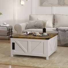 a living room filled with furniture and a coffee table on top of a wooden floor