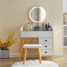 a vanity with a mirror and stool in a room