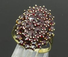 14K GOLD - Vintage Shiny Garnet Cluster Victorian Cocktail Ring Sz 8 - GR077  14K GOLD - Vintage Shiny Garnet Cluster Victorian Cocktail Ring Sz 8 - GR077  Jewelry Type:         Ring   Metal Type:            14K Gold   Metal Size:             8 Finger   Stone Type:            Garnet   Condition:              N/A  Jewelry Weight:     6.5 Grams  PLEASE NOTE: THIS ITEM IS PRE-OWNED. ALTHOUGH MOST ITEMS ARE IN VERY GOOD CONDITION, SOME MAY NEED CLEANING AND/OR MINOR REPAIRS. WE MAKE A VERY STRONG EF Gold Cluster Ruby Ring As Gift, Gold Cluster Ruby Ring Hallmarked, Gold Cluster Ruby Ring, Hallmarked, Clear Pictures, Ring Metal, Cocktail Ring, Cocktail Rings, All Pictures, Beautiful Rings