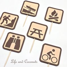 six wooden signs that say life and coconuts are on top of sticks with stickers