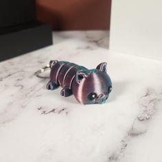 a small metal animal sitting on top of a white counter