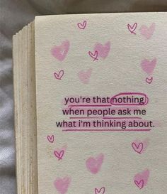 an open book with pink hearts on it and the words you're that nothing when people ask me what i'm thinking about