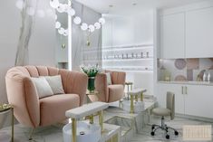 a living room filled with lots of furniture next to a white counter top and gold accents