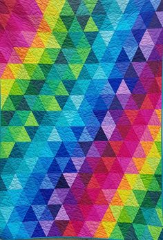 a multicolored quilt with triangles on it