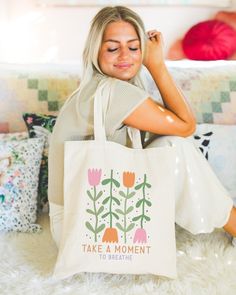 "This Retro Floral Tote makes the perfect bag for anyone looking to rock that simplistic boho style while also reminding themselves and those around them that its good to take a moment and breathe. Perfect as a gift or to treat yourself! The tote bag is made from sturdy, high-quality 100% cotton canvas, which makes it perfect for carrying books, groceries, or anything else you need to take with you. It measures approximately 15.75\"h x 15.25\"w with a handle length of 21.5\", with a roomy interior and comfortable handles that make it easy to carry. Please message us if you have any questions! Check out more of our unique designs in our shop!" Canvas Bag Design Diy, Paint Canvas Bag, Canvas Bag Ideas, Tote Bag Painting Ideas Easy, Canvas Bag Painting, Cool Tote Bag Design, Paint Tote Bag, Bible Tote Bag, Diy Tote Bag Design