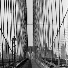 an old black and white photo of the brooklyn bridge