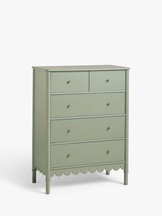 a green dresser with scalloped drawers