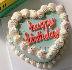 a heart shaped birthday cake with the words happy birthday written in frosting on it