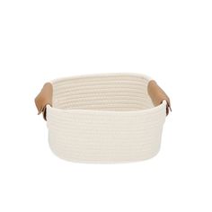 a white basket with brown handles