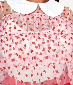 This sweet plus size crop top is crafted in a fabulous pink sheer mesh that dances with red glitter hearts. The relaxed ruffled silhouette boasts a contrasting white Peter Pan collar and three-quarter length sleeves. Cami Sold Separately. Available in sizes XS-4X while supplies last. Plus Size Crop Top, Plus Size Crop Tops, Plus Size Pink, Pink Sheer, Glitter Hearts, Red Glitter, Pan Collar, Ruffle Top, Peter Pan Collar