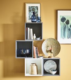 the shelves are arranged in different shapes and sizes, including one with a fan on top