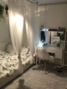 a bedroom with a bed, desk and mirror