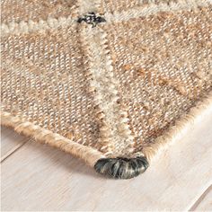 an area rug on the floor that is made out of wood and jute fabric