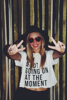 a woman wearing sunglasses and a t - shirt that says not going on at the moment