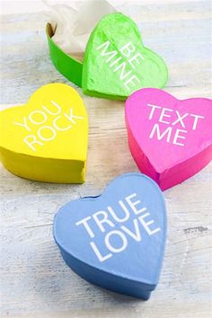 three conversation hearts with the words true love written on them in different colors and shapes