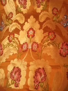 an orange and pink floral design on fabric