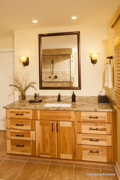 a bathroom with two sinks and a large mirror over it's counter top area