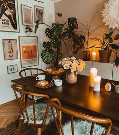 a dining room table with flowers and candles on it