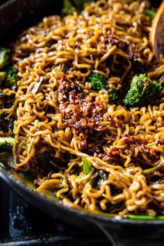 a skillet filled with noodles and broccoli