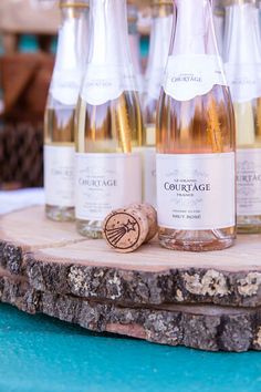 several bottles of wine sitting on top of a wooden board