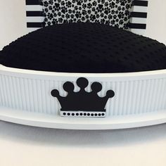 a black and white bed with a crown on it