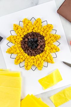 a sunflower made out of crochet yarn on top of a piece of paper