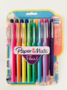 a box of assorted colored paper mate pens